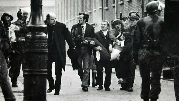 Fr Edward Daly leads the group carrying the body of Jack Duddy, who was shot dead in Derry on Bloody Sunday. Photo: Stanley Matchett/Getty Images