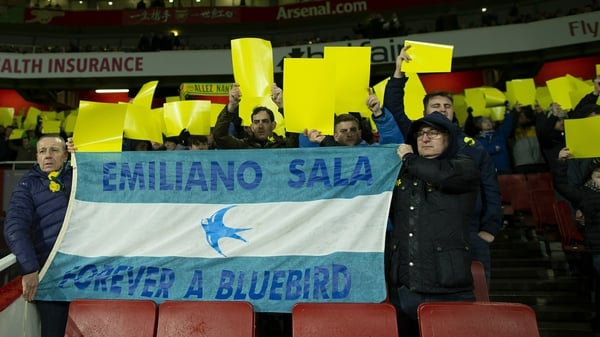 Fans display a tribute flag to Emiliano Sala
