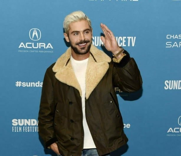 Zac Efron, who portrays serial killer Ted Bundy in "Extremely Wicked, Shockingly Evil and Vile," waves to photographers at the premiere of the film during the 2019 Sundance Film Festival, Saturday, Jan. 26, 2019, in Park City, Utah. (Photo by Chris Pizzello/Invision/AP)