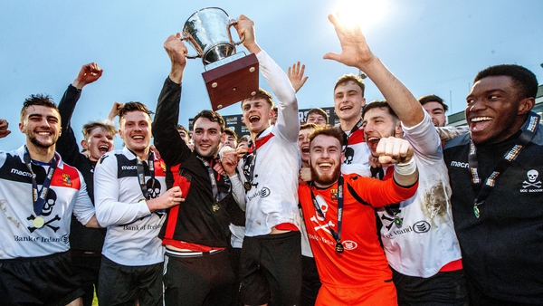 UCC's Daniel Pender and Robert Slevin lift the trophy beside their team-mates