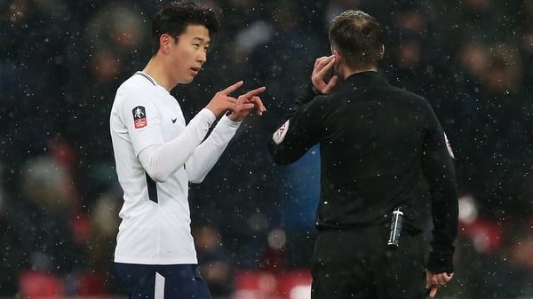 Spurs' Heung-Min Son asks a referee for a VAR review in last season's FA Cup