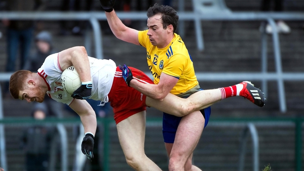 Tyrone's Cathal McShane is chellenged by Roscommon's Niall Kilroy