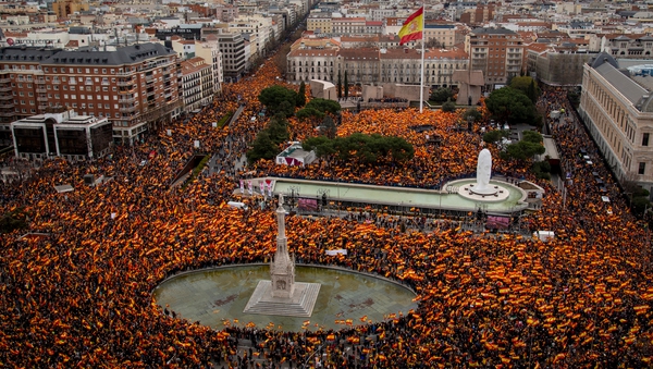 Protesters wave Spanish flags during a demonstration against Prime Minister Pedro Sanchez in Colon Square, Madrid