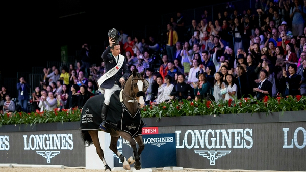 Denis Lynch and Chablis salute the crowd after winning the Longines Masters of Hong Kong Grand Prix