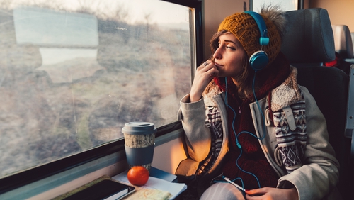 Peaceful girl in modern wireless headphones sit relax on