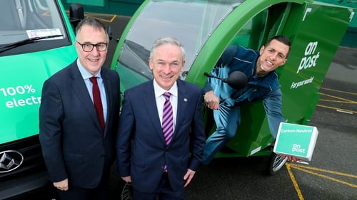 Richard Bruton (C) David McRedmond (L) and postal operative Keith Lally at the launch of the initiative