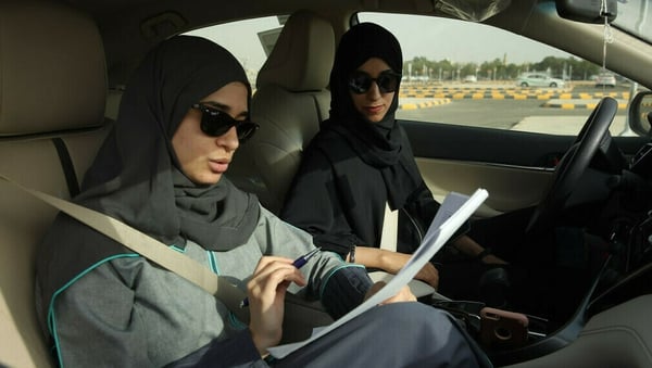 A student and instructor practice driving in Saudi Arabia