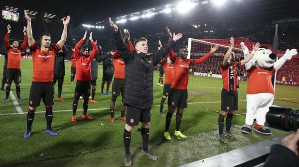 Rennes players, and mascot, celebrate their win against Arsenal in the Europa League