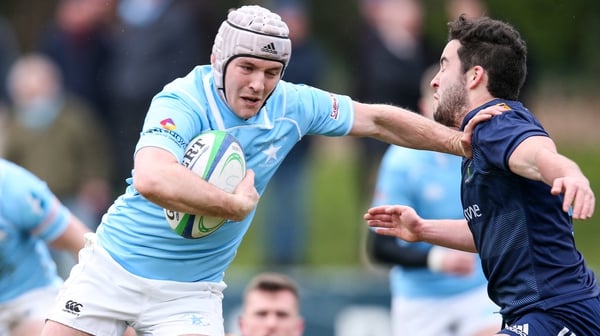 Rob Guerin barges past UCD's Paddy Patterson to take his try