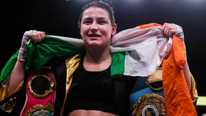 Katie Taylor with her three belts - the final piece of the collection may land in the summer