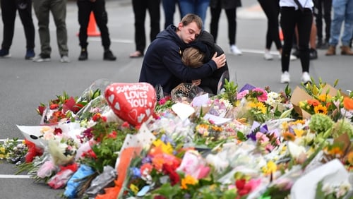 Members of the public mourn at a flower memorial near the Al Noor Mosque in Christchurch