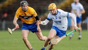 Waterford's Peter Hogan and Jack Browne of Clare compete for possession