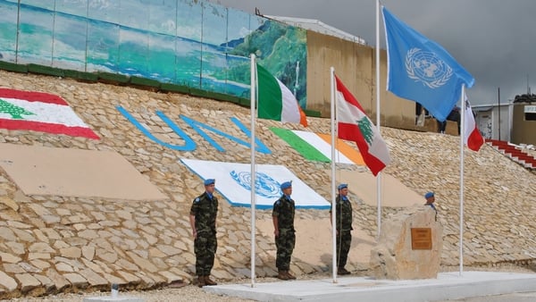 The Irish, UN and Lebanese flags flying during a medal parade in UNIFIL Lebanon