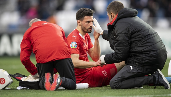 Fabian Schar (C) was given the okay to continue by medics