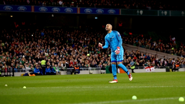 Darren Randolph clears the pitch of tennis balls