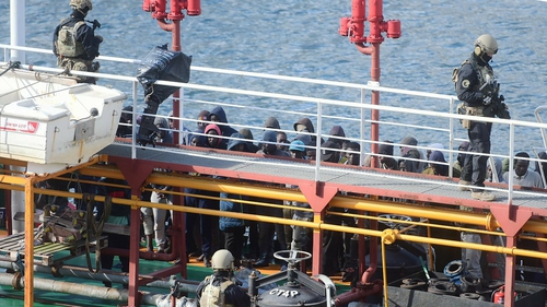 Maltese special forces guard the migrants after the ship docked in Valetta