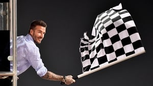 David Beckham waves the checkered flag as Mercedes' Lewis Hamilton crosses the finish line in Bahrain