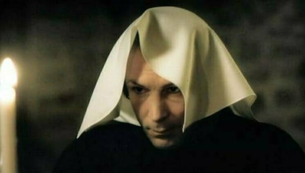 Aiden Gillen as Charles Haughey in RTÉ's 'Charlie' series beginning to eat an Ortolan bird.