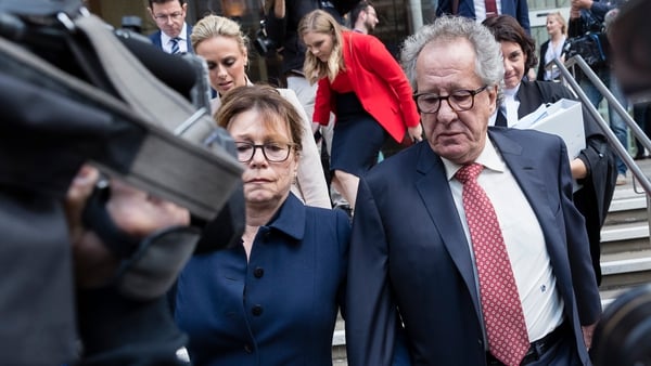 Geoffrey Rush and his wife Jane Menelaus pictured leaving the Supreme Court of New South Wales