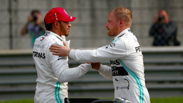 Valtteri Bottas shakes hands with second placed qualifier Lewis Hamilton