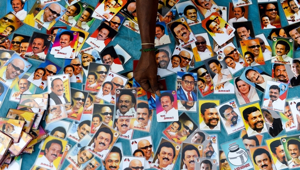 An Indian vendor arranges photos of Dravida Munnetra Kazhagam (DMK) party president M. K. Stalin during an election rallyin Sriperumbudur in the Tamil Nadu state. Photo: Arun Sankar/AFP/Getty Images