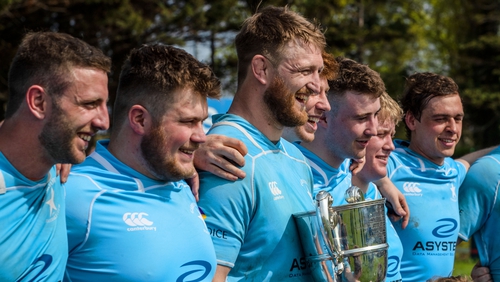 Garryowen's Dean Moore celebrates with team mates and the Bateman Cup