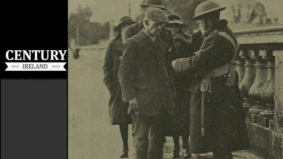 Century Ireland Issue 151 - A sentry checking permits as people re-enter the city
Photo: Illustrated London News [London, England], 26 April 1919