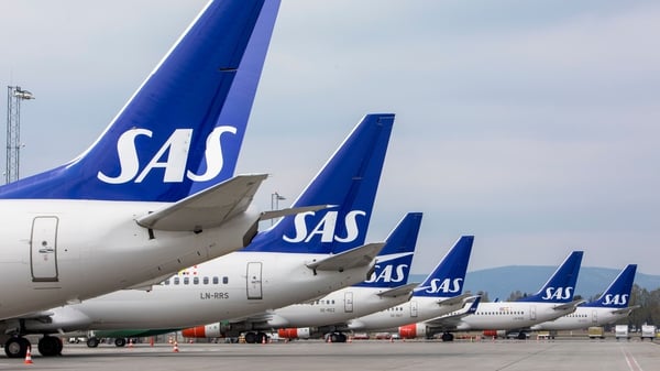 SAS blamed the impact of recent strikes as well as delays in aircraft deliveries for the cuts