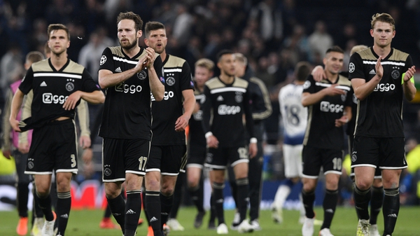 Ajax players celebrate at the final whistle
