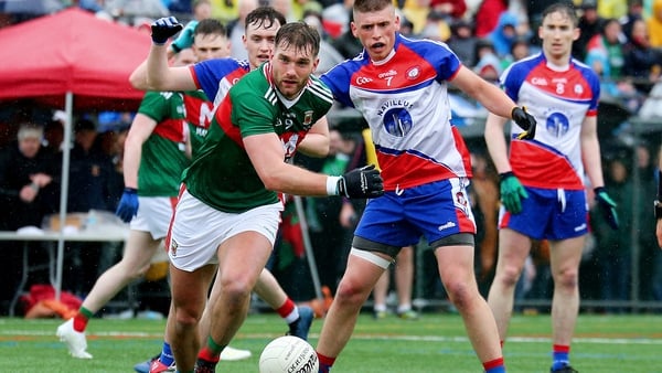 Aidan O'Shea battles for the ball with Matthew Queenan