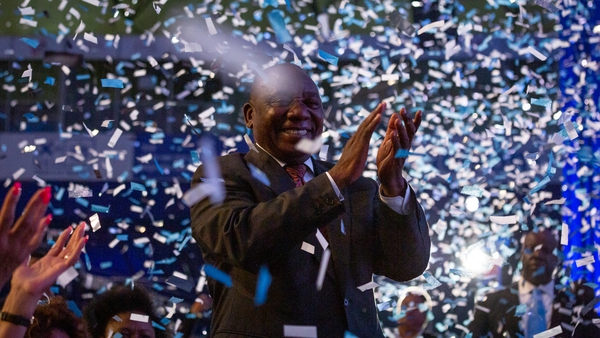 South African President Cyril Ramaphosa cheers during the results announcement ceremony