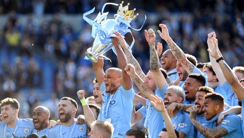 Manchester City captain Vincent Kompany lifts the Premier League trophy