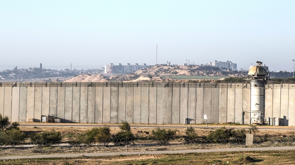 Buildings can be seen in Gaza behind the border wall built by Israel