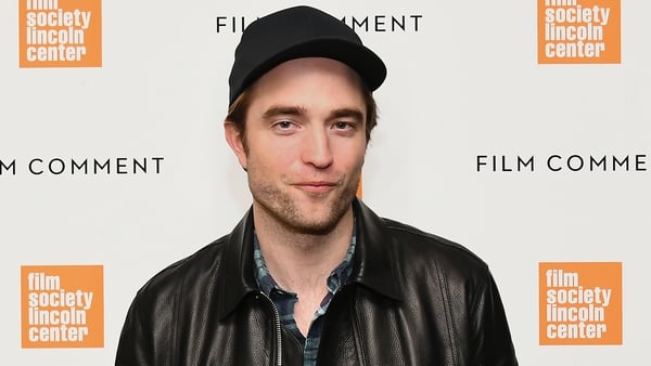 Robert Pattinson donning his cape for The Batman