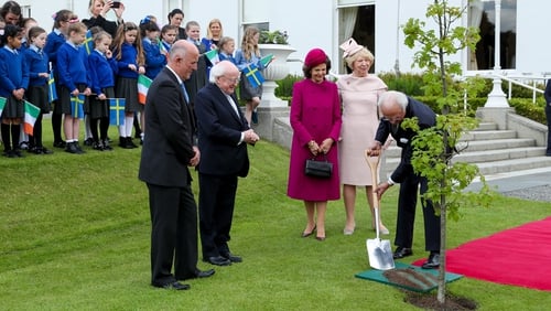 Michael D Higgins at Arás an Uachtarán watches King Carl XVI Gustaf plant a tree