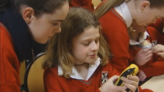 Schoolgirls looking at mobile phone (2004)
