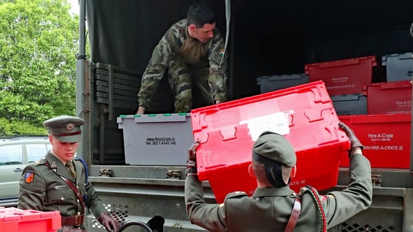 Members of the Defence Forces load ballots on to trucks at the RDS in Dublin for transport to other count centres