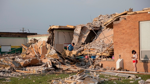 People examine the damaged remains of school in Dayton, Ohio