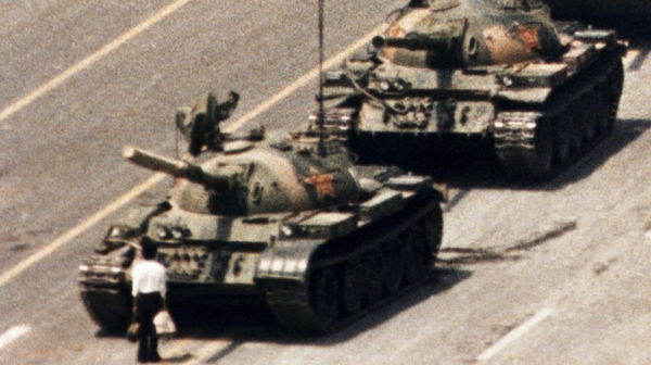 A lone demonstrator halts a column of tanks at Tiananmen Square, the day after Chinese troops fired on pro-democracy students