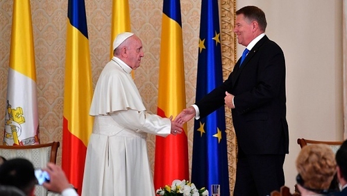 Pope Francis and Romania's President Klaus Iohannis shake hands at the Presidential Palace in Bucharest