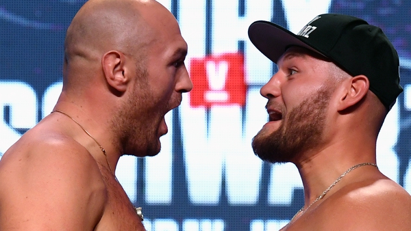 Tyson Fury (l) and Tom Schwarz face off