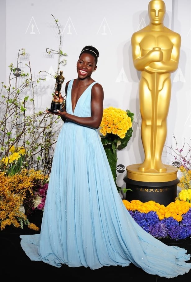 Lupita Nyong'o in Prada, with her award for Best Supporting Actress (Ian West/PA)