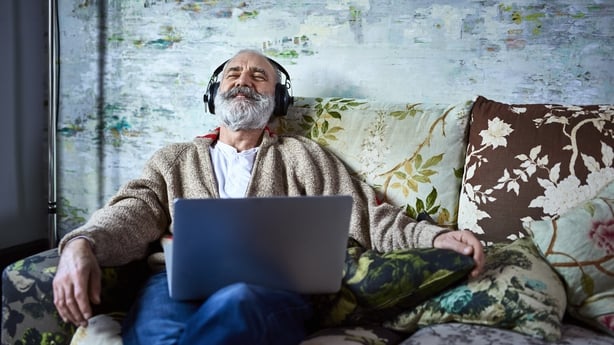 man listening to music on his laptop