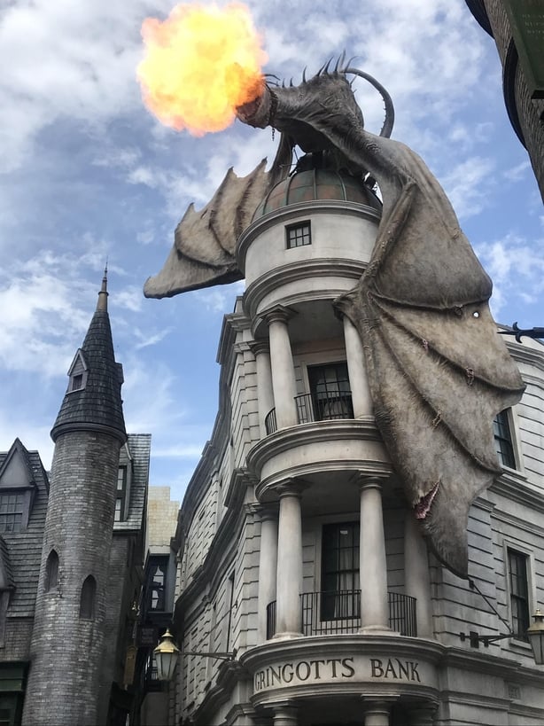 Muggles wandering the magical alleyway may be startled by the fire-breathing dragon atop of Gringott's bank (Jemma Crew/PA)
