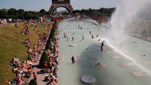 People bathe in the Trocadero Fountain near the Eiffel Tower in Paris