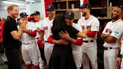 Meghan embraces Red Sox player Mookie Betts. Image: PA