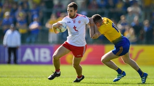 Niall Sludden of Tyrone is tackled by Cathal Cregg of Roscommon