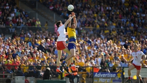 Diarmuid Murtagh of Roscommon takes to the skies with Rory Brennan of Tyrone