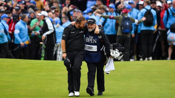 Shane Lowry chats to his caddie Brian 'Bo' Martin as they come down the last fairway at Royal Portrush