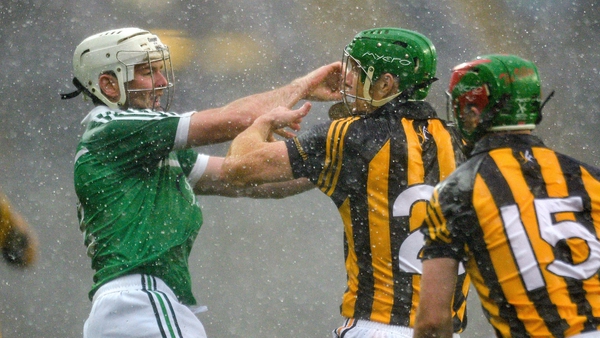 Tom Condon of Limerick does battle with Kilkenny's Henry Shefflin